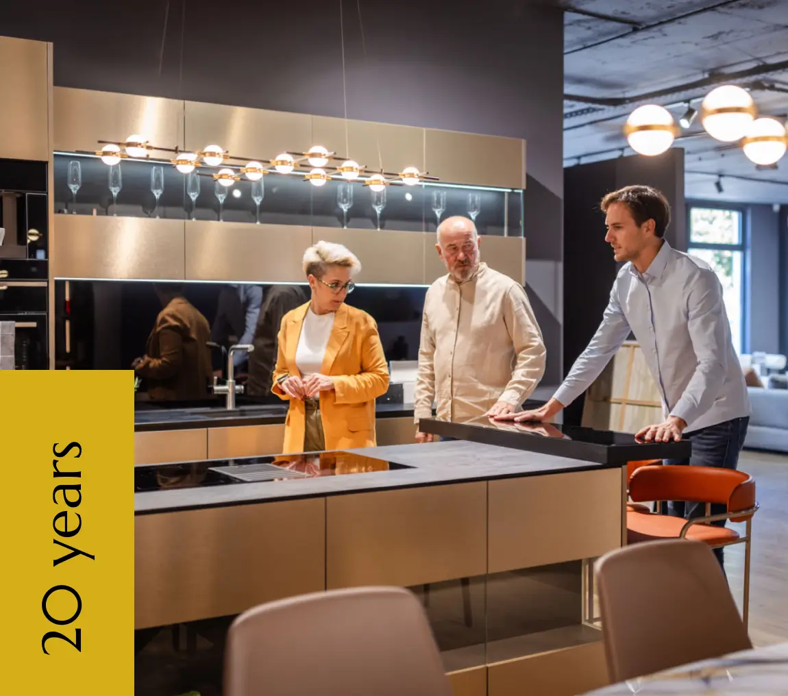 Couple consulting salesperson about modern kitchen island